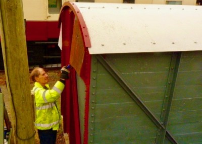 Malcom gets to grips with the first top coat. The newly fitted roof securing hoops can be seen also.